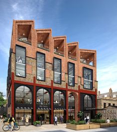 an artist's rendering of a brick building with people walking and biking on the sidewalk