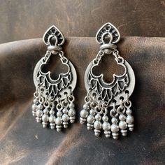 These Boho Silver Dangle Earrings with Beaded Fringe offer a unique blend of elegance and bold style. Featuring a distinctive Ethnic Floral Drop Design, the earrings are adorned with a beaded fringe that adds a playful yet sophisticated movement to their look. Perfect for those who appreciate Vintage Style Statement Jewelry, these earrings are ideal for women who love to mix bohemian and ethnic influences in their wardrobe, enhancing both casual everyday outfits and more refined, eclectic ensemb Bohemian Accessories, Drop Design, Bold Style, Silver Dangle Earrings, Beaded Fringe, Drops Design, Style Statement, Silver Earrings Dangle, Casual Everyday