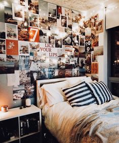 a bedroom with pictures on the wall and lights hanging above it, along with a bed