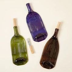 three empty wine bottles sitting next to each other