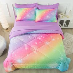 a bed with colorful comforters and pillows