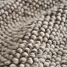 a close up view of the texture of a rug with white and black dots on it