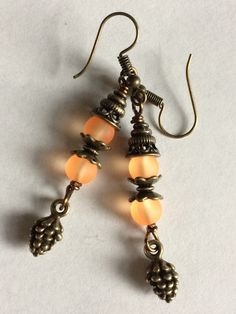 "Cute Bronze Fall Earrings  They are 1.5 \" in Length and are made with Frosted Glass Beads and Rustic Bead caps and a pine Cone Charm" Tree Of Life Earrings, Orange Crystals, Pumpkin Earrings, Fall Earrings, Yellow Earrings, Triangle Earrings, Fall Jewelry, Pine Cone, Dangle Charms