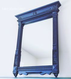 a blue mirror sitting on top of a shelf