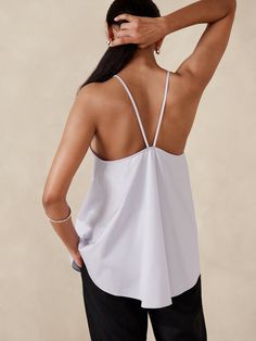 Ready for warm weather, we cut this billowing trapeze tank with a swingy silhouette.  For fabric we reached for our signature stretch-cotton poplin, a fabric we love for its timeless look and crisp feel against the skin.  Trapeze Fit: Cut for a flowing, A-line fit.  No waist definition.  Crew neck.  Fixed (non-adjustable) straps.  Straight hem.  Trapeze Fit: Cut for a flowing, A-line fit.  No waist definition.  Sleeveless.  Hip length.  Model: Size S, 5'10" (178cm). Versatile Spring Tank Top With Spaghetti Straps, Versatile Cotton Camisole For Summer, Versatile Spaghetti Strap Tank Top For Spring, Stretch Camisole For Daywear In Spring, Stretch Tank Top For Summer Daywear, Spring Stretch Camisole For Daywear, Spring Sleeveless Relaxed Fit Camisole, Sleeveless Relaxed Fit Camisole For Spring, Relaxed Fit Sleeveless Spring Camisole