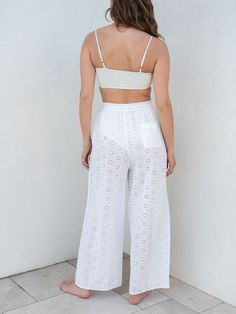 Our Daisy Eyelet Coverup comes in pants now too. This coverup features a delicate daisy eyelet pattern, a relaxed elastic waist which makes them perfect to throw over your favorite swimsuit. From the beach to the pool deck or right on to lunch in town, these pants are the coverup of the season. White Cotton Bottoms With Eyelet Details, Summer Long Pants For Poolside, Casual Eyelet Bottoms For Summer, White Summer Bottoms For Warm Weather, White Bottoms For Summer Warm Weather, Beachy Bottoms For Spring And Summer Outings, Beachy Bottoms For Summer Outings, High Waist Beachwear Pants For Spring, Spring Beachwear Pants For Day Out