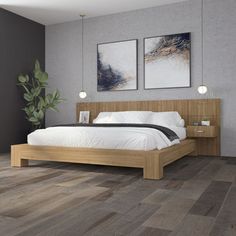 a bedroom with wood floors and gray walls, two pictures on the wall above the bed