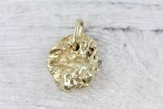 N7804  Vintage 14K Yellow Gold Nugget Pendant Charm Retro Pretty Luxury  AMAZING SOLID 14KT GOLD PENDANT. GREAT NUGGET RAW DESIGN. WONDERFUL HIGHEST QUALITY. JUST PART OF MY MOST RECENT ESTATE FINDS! FOLLOW ME TO SEE THEM ALL!  Brand:   Metal: 14K Yellow Gold Material:  Form: Nugget Pendant Charm Retro Pretty Luxury Size :3/4 x 1/2 Age: Vintage Weight (Grams): 5.5 IT IS IN EXCELLENT ESTATE CONDITION  ALL ITEMS LISTED AS  GOLD ARE EITHER MARKED AND OR TESTED FOR CONTENT  TO HELP DETERMINE SIZE / Raw Design, Nugget Necklace, Blue Topaz Pendant, Gold Nugget, Heart Pendant Diamond, Star Pendant, Gold Charm, Diamond Heart, 14kt Gold