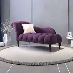 a purple chair sitting on top of a white rug