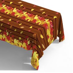 an image of a table with autumn leaves on it