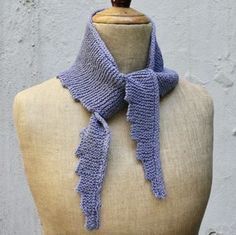 a mannequin wearing a purple knitted scarf