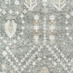 an area rug with many different patterns and colors on the carpet, including greys