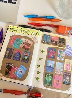 an open notebook with stickers and pens on it