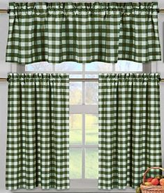 a green and white checkered window curtain in front of a window with apples next to it