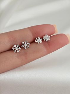 Welcome winter with these beautiful sterling silver tiny snowflake earring studs! The minimalist design is perfect to adorn your ears and keep you feeling festive all season long. Crafted with hypoallergenic sterling silver, these gorgeous earrings are sure to be a welcome addition to any winter wardrobe. They are both light and comfortable, so you can go about your days without feeling weighed down. These earrings are the perfect accessory for the winter season and make a thoughtful gift for th Snow Flake Earrings, Christmas Earrings Aesthetic, Elegant Christmas Earrings, Winter Accessories Jewelry, Tiny Snowflake, Preppy Earrings, Wishlist Ideas, Snowflake Jewelry, Silver Butterfly Earrings