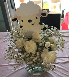 a vase filled with white flowers on top of a table