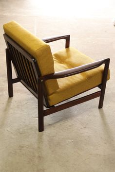 a yellow chair sitting on top of a white floor