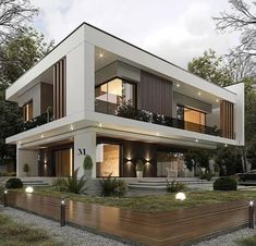 this is an image of a modern house in the evening time with its lights on