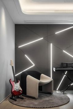 a living room with a guitar, piano and chair