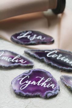 some purple rocks with names on them