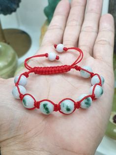 9 pcs of beautiful Moss in Snow Jade beads (10 mm size) woven together to make this beautifully handcrafted, adjustable Red Thread Bracelet. A pair of white Jade beads were used for the adjusters. All Jade bead components are Type A natural Jadeite (non-bleached, non-dyed, non-treated materials). Good health, wealth, prosperity & good luck . For customers with much bigger fist and wrist, you can send us a direct message after your payment so we can customized the size before shipping. Traditional Adjustable Jade Bracelets, Traditional Adjustable Jade Bracelet, Red Beaded Bracelets With Gemstone Beads, Handmade Red Jade Bracelets, Adjustable Red Jade Bracelet, Green Hand-strung Braided Bracelet With Round Beads, Green Hand-strung Braided Bracelets, Spiritual Red Braided Bracelets With Round Beads, Spiritual Red Braided Bracelet With Round Beads