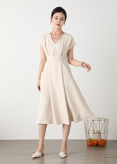 "Cool and comfortable for hot summer days, this beige dress is elegant and stylish.    It is a wonderful wardrobe staple that's a timeless classic you'll wear again and again. All our items are Tailored and Handmade and Made to Order ,I can make Any Size . I design new styles every week, please collect my store. I believe that you will meet your favorite styles. ★★FEATURES Polyester fabric Two side pockets Back zipper closure V neck Short sleeve Midi dress Casual dress Beige dress Simple dress P Beige Long Dress, Beige Long Dresses, A Line Dress Short, Dress Beige, Dress Handmade, Dress A Line, Beige Dresses, Dress Short Sleeve, Midi Dress Casual