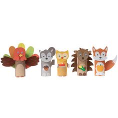 an assortment of wooden animals with leaves on them