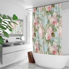 a bathroom with a tub, sink and shower curtain that has pink roses on it