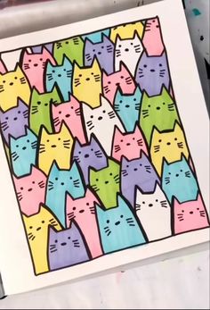 there are many colorful cats on the paper