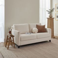 a living room scene with focus on the couch and side table in the foreground