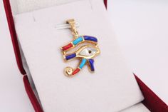 Colored Eye of Horus 18K gold Pendant | handmade jewelry Egyptian jewelry evil eye pendant mythology jewelry eye necklace Horus charm 3.2 Gr Weight Approximate : 3.2 Gr Height : 1.2" = 31 mm Width : 1" = 27 mm ✔ IT IS Tested & SIGNED WITH THE EGYPTIAN Gold Government HALLMARK FOR 18K GOLD to Ensure      Authenticity. ✔ Lovely gift idea ABSOLUTELY GORGEOUS, LOOKS FABULOUS ON. ✔ 100% Egyptian handmade. ✔ Condition: A brand-new, exactly as on the photos. ★ GIFTS ✔ All items are packaged in a paper Gold Amulet Jewelry With Diamond Eyes, Symbolic Pendant With Diamond Eyes, Brass Evil Eye Jewelry As A Gift, Brass Evil Eye Jewelry For Gifts, Evil Eye Brass Jewelry As A Gift, Symbolic Eye-shaped Jewelry Gift, Amulet Style Jewelry With Diamond Eyes For Gift, Gold Evil Eye Pendant Jewelry, Evil Eye Pendant Jewelry For Good Luck