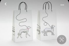 two bags with dogs drawn on them sitting next to each other in front of a white background