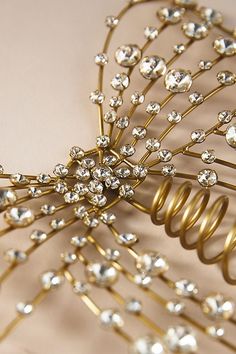 a gold hair comb with lots of crystals on it