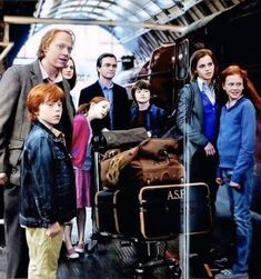 a group of people standing next to each other in front of an airport luggage cart