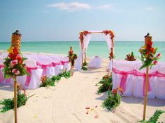 an outdoor wedding set up on the beach