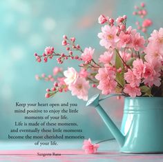 a blue watering can with pink flowers in it and a quote on the side that says, keep your heart open and you mind positive to enjoy the little moments of your life