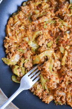 a blue plate topped with meat and vegetables