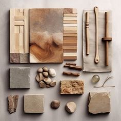 various types of wood and stone are arranged on a table with scissors, spoons, napkins, and other items