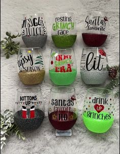 six wine glasses with different sayings on them sitting on a white furnishing