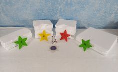 three stars are placed next to each other on a white tablecloth with blue wallpaper in the background