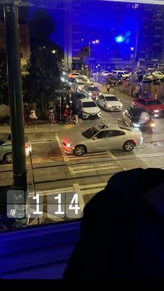 a city street filled with lots of traffic at night