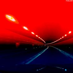 an image of a car going down the road at night time with red lights on it