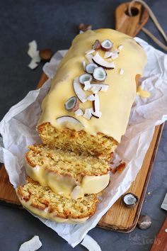 there is a loaf of cake with white frosting on it and sliced into slices