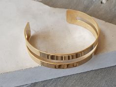 This trendy 14K Gold-filled Cuff Bracelet is inspired by the beauty and appeal of simplicity. It makes the perfect addition to any look. This minimalist bracelet for women features 2 plain cuffs that when attached to each other create one modern cuff. PRODUCT DETAILS: 14K Gold-filled Shiny finish and smooth 10mm wide bracelet Open cuff - will fit most wrist MATERIALS: 14K Gold Filled 14K Gold Filled jewelry is not the same as gold-plated jewelry. It contains 5% of solid gold and is done by a pro Modern Gold Double Band Cuff Bracelet, Gift Double Band Cuff Bracelet, Minimalist Open Cuff Bracelet, Gold Minimalist Bracelet With Double Band, Gold Minimalist Double Band Bracelet, Minimalist Double Band Gold Bracelet, Minimalist Adjustable Open Band Bracelets, Minimalist Adjustable Open Band Bracelet, Adjustable Yellow Gold Minimalist Cuff Bracelet