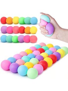 a hand is holding a toy with colored balls in it