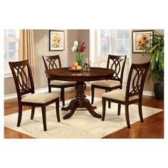 a dining room table with four chairs around it