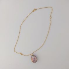 This premium-quality Chinese Freshwater pearl pendant features a bead-nucleated pearl affixed to an 18K yellow gold bail. The pearl has an organically smooth baroque shape, measuring 17-18 by 23mm and weighing 5.2g. If paired with an optional chain, the total weight comes to 6.7g. Displaying a naturally metallic blend of purple, pink, and peach hues, accented by green and pink overtones, the pearl has a luminous glow. The pearl's surface is clear, which allows its stunning beauty to be fully app Luxury Drop Pearl Necklace For Gift, Gold Baroque Pearl Drop Necklaces, Handmade Gold Pearl Necklace With Briolette, Gold Baroque Pearl Teardrop Pendant Necklace, Luxury Teardrop Pearl Necklace Gift, Luxury Teardrop Pearl Necklace For Gift, Yellow Gold Teardrop Pearl Pendant Necklace, Yellow Gold Pearl Necklace With Teardrop Pendant, Teardrop Baroque Pearl Jewelry With High Luster