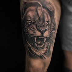 a man's arm with a tiger tattoo on it