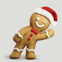 a gingerbread man with a santa hat and bow tie is standing in front of a gray background