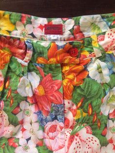 Cool Kenzo Paris multi colored floral printed high waisted shorts. Perfect 80's high fashion street wear. Fabric is a medium weight cotton. Shorts have pleats in the front, darts at the waist in back. Side front pockets. Cuff at the shorts hem. Front plastic zipper with button at the waist. Label Kenzo Paris, Size 38, 100% cotton, wash cold, hang dry. Very good vintage condition with no fabric or sewing flaws. Measurements Waist 62cm/ 24.5inches Hips 102cm/ 40inches Waist to hem 44cm/ 17inches M Retro Cotton Shorts For Spring, Retro Printed Bottoms For Spring, Retro Floral Print Short Bottoms, Green Cotton Bottoms With Floral Print, Green Floral Print Cotton Bottoms, Retro Floral Print Shorts, Retro Floral Print Bottoms For Spring, Vintage Floral Print Bottoms For Spring, Cotton Floral Print Shorts For Spring